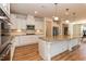 White kitchen with stainless steel appliances, granite countertops, and a large island at 3536 Greenville Loop Rd, Wake Forest, NC 27587