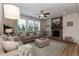 Cozy living room features a stone fireplace, neutral décor, ceiling fan and plenty of natural light at 3536 Greenville Loop Rd, Wake Forest, NC 27587