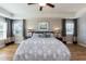 Spacious bedroom with tray ceilings, wood floors, ceiling fan, and two windows at 3536 Greenville Loop Rd, Wake Forest, NC 27587
