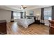 Spacious bedroom with beautiful wood floors, tray ceilings, two windows, and ceiling fan at 3536 Greenville Loop Rd, Wake Forest, NC 27587