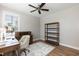 Bright home office features a ceiling fan, wood floors, desk and a bookshelf at 3536 Greenville Loop Rd, Wake Forest, NC 27587