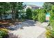 Spacious paver patio complemented by mature trees and blooming plants at 3536 Greenville Loop Rd, Wake Forest, NC 27587
