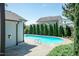 In-ground pool with lush greenery and a glimpse of neighboring homes, offering a serene backyard retreat at 3536 Greenville Loop Rd, Wake Forest, NC 27587