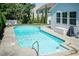 In-ground pool with concrete patio, ladder, patio furniture, and green trees at 3536 Greenville Loop Rd, Wake Forest, NC 27587