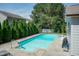 In-ground pool surrounded by green trees with lounge chairs and a clear blue sky at 3536 Greenville Loop Rd, Wake Forest, NC 27587