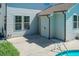 View of the concrete patio and in-ground pool with ladder and an exterior view of the light blue siding at 3536 Greenville Loop Rd, Wake Forest, NC 27587