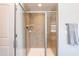 Shower featuring a glass door, tiled walls, and modern showerhead at 3536 Greenville Loop Rd, Wake Forest, NC 27587