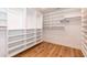 Spacious walk-in closet with custom shelving and hardwood floors at 3536 Greenville Loop Rd, Wake Forest, NC 27587