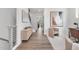 Bright hallway with hardwood floors, modern artwork, and stylish furniture at 3908 Lost Fawn Ct, Raleigh, NC 27612