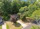 An aerial view showcases home with mature trees, manicured lawn, and concrete driveway at 4119 Toroella St, Durham, NC 27704