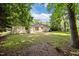A view of the home's backyard featuring lawn and exterior wall of the home at 4119 Toroella St, Durham, NC 27704