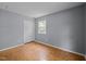 Bedroom featuring parquet floors, closet and large windows offering plenty of natural light at 4119 Toroella St, Durham, NC 27704
