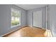 Bedroom featuring parquet floors, closet and a large window offering lots of natural light at 4119 Toroella St, Durham, NC 27704