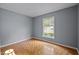 Bedroom featuring parquet floors and a large window offering lots of natural light at 4119 Toroella St, Durham, NC 27704