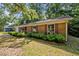 Charming single-story home with brick exterior, dark shutters, and a well-manicured lawn at 4119 Toroella St, Durham, NC 27704