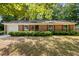 Charming brick home featuring manicured front yard with lush green hedges and brick-lined flowerbeds at 4119 Toroella St, Durham, NC 27704
