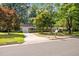 Charming brick home with driveway, manicured lawn, mature trees in a quiet neighborhood at 4119 Toroella St, Durham, NC 27704