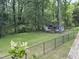 Backyard view with wooden shed and black fence at 4220 Hope Valley Road Rd, Durham, NC 27707