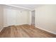 Unfinished basement featuring wood-look flooring, neutral walls and a door to an adjacent room at 4220 Hope Valley Road Rd, Durham, NC 27707