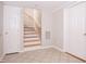 Basement access to stairs with tile floors, two doors, and wooden steps at 4220 Hope Valley Road Rd, Durham, NC 27707
