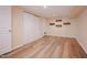 Well-lit basement area with modern wood-look flooring, closet, and neutral tones, ready for customization at 4220 Hope Valley Road Rd, Durham, NC 27707