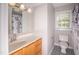 Small bathroom with fresh paint and new, modern tile flooring at 4220 Hope Valley Road Rd, Durham, NC 27707
