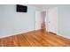 Bedroom featuring hardwood floors, a mounted television, and access to an additional room at 4220 Hope Valley Road Rd, Durham, NC 27707