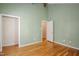 Secondary bedroom with light, fresh paint, hardwood floors and vaulted ceilings at 4220 Hope Valley Road Rd, Durham, NC 27707