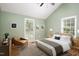 This primary bedroom has a cathedral ceiling, ensuite bathroom and a leather reading chair at 4220 Hope Valley Road Rd, Durham, NC 27707