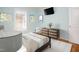 Staged bedroom with artwork, hardwood floors, and a mounted television at 4220 Hope Valley Road Rd, Durham, NC 27707