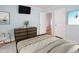 Staged bedroom with artwork, hardwood floors, a dresser and a mounted television at 4220 Hope Valley Road Rd, Durham, NC 27707