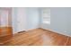 Bedroom featuring hardwood floors, a window and access to an additional room at 4220 Hope Valley Road Rd, Durham, NC 27707