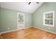 Empty bedroom features a vaulted ceiling, hardwood floors, and natural light through the windows at 4220 Hope Valley Road Rd, Durham, NC 27707