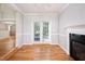 Dining area with hardwood floors, fireplace, and french doors leading to the backyard at 4220 Hope Valley Road Rd, Durham, NC 27707