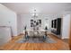 Staged dining room with modern decor, marble table, and stylish rug at 4220 Hope Valley Road Rd, Durham, NC 27707