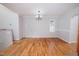 Bright dining room with hardwood floors, chandelier, and neutral wall paint at 4220 Hope Valley Road Rd, Durham, NC 27707