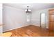 Bright dining room with hardwood floors, chandelier, and neutral wall paint at 4220 Hope Valley Road Rd, Durham, NC 27707