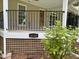 Front porch with black railings, a wood door and house number 4220 at 4220 Hope Valley Road Rd, Durham, NC 27707