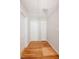 Upstairs hallway with hardwood floors and white doors at 4220 Hope Valley Road Rd, Durham, NC 27707