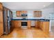 Well-lit kitchen with stainless steel appliances, blue countertops, and wooden cabinets at 4220 Hope Valley Road Rd, Durham, NC 27707