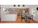 Bright kitchen features stainless steel appliances, hardwood floors, and an adjacent dining area at 4220 Hope Valley Road Rd, Durham, NC 27707