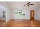 Bright living room with hardwood floors, large window, and wooden door at 4220 Hope Valley Road Rd, Durham, NC 27707