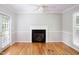 Cozy living room with a fireplace, hardwood floors, and a door leading to the backyard at 4220 Hope Valley Road Rd, Durham, NC 27707