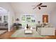 Staged living room with hardwood floors, large window, and wooden door at 4220 Hope Valley Road Rd, Durham, NC 27707