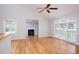 Living room featuring hardwood floors, fireplace, and large window at 4220 Hope Valley Road Rd, Durham, NC 27707