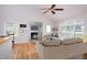 Staged living room featuring hardwood floors, fireplace, and large window at 4220 Hope Valley Road Rd, Durham, NC 27707