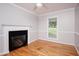 Charming room with fireplace, hardwood floors, natural light from a large window at 4220 Hope Valley Road Rd, Durham, NC 27707