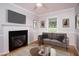 Comfortable living room with a fireplace, modern decor, and ample natural light at 4220 Hope Valley Road Rd, Durham, NC 27707