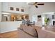 Staged living room with hardwood floors, vaulted ceiling, and open layout to the kitchen at 4220 Hope Valley Road Rd, Durham, NC 27707