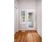 Mud room featuring a window and glass door to deck, hardwood floors, and a closet at 4220 Hope Valley Road Rd, Durham, NC 27707